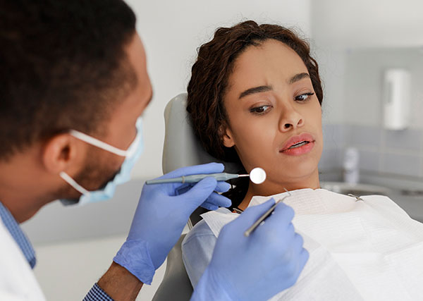 young lady is anxious at the dentist; dental anxiety